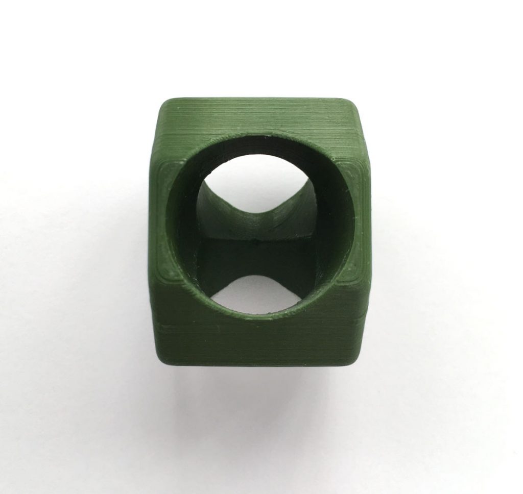 Octagonal green woggle with Scouting Logo